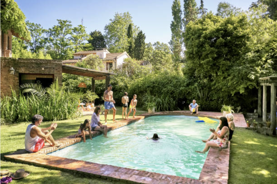 A happy family after a Custom Pool Construction is completed